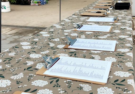 A line of clipboards at the registration table